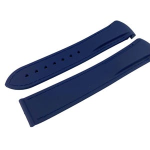May include: Two dark blue watch straps made of rubber. The straps have a smooth, textured surface and are designed for a watch with a lug width of 20mm.