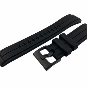 May include: Black rubber watch strap with a black buckle. The strap has a textured surface and is designed for a watch with a 22mm lug width.