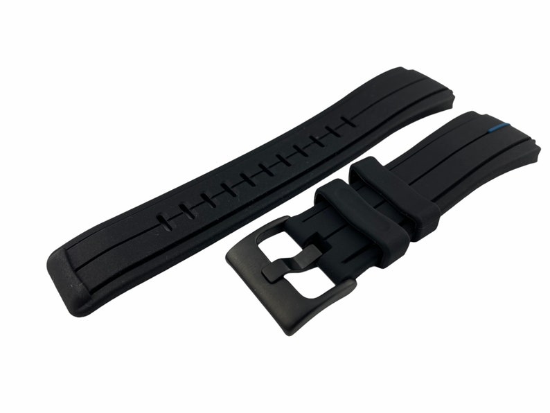 May include: Black rubber watch strap with a black buckle. The strap has a textured surface and is designed for a watch with a 22mm lug width.