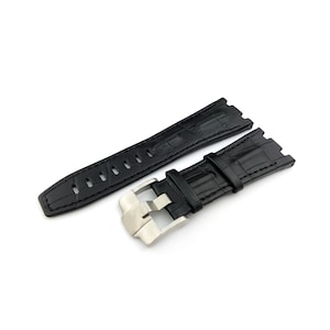 May include: Black leather watch strap with a silver buckle. The strap has a crocodile pattern and is designed for a watch with a lug width of 22mm.