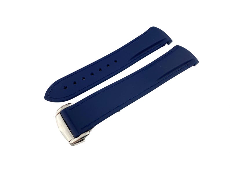 May include: A pair of blue rubber watch straps with silver buckles.