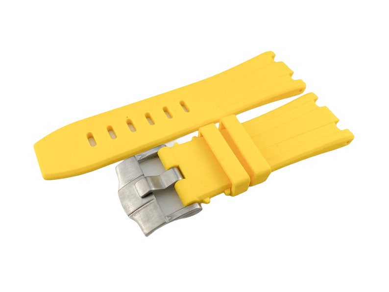 May include: A yellow rubber watch strap with a silver buckle. The strap has a textured surface and is designed for a watch with a lug width of 22mm.