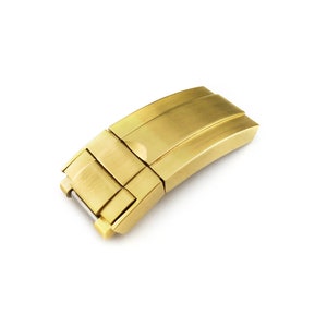 K&ouml;nnte beinhalten: Ein goldfarbener Metall-Uhrenarmbandverschluss mit geb&uuml;rsteter Oberfl&auml;che.