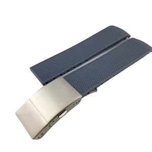 May include: A grey silicone watch strap with a silver buckle. The strap has a textured surface.
