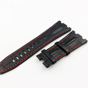 May include: Black leather watch strap with red stitching. The strap has a crocodile pattern and is designed for a watch with a lug width of 22mm.
