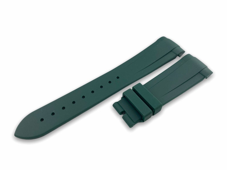 May include: A dark green rubber watch strap with a buckle. The strap has a textured surface and is designed for a watch with a 22mm lug width.