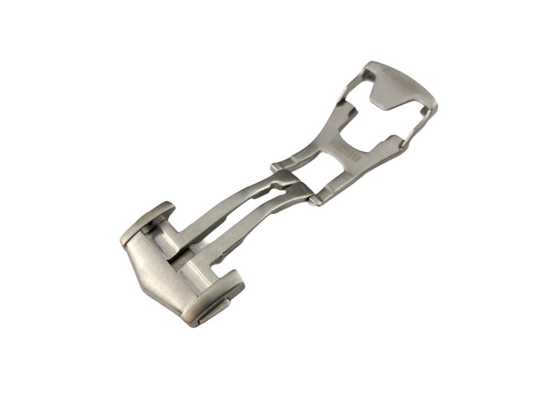 May include: A silver metal watch band clasp with a push-button release.