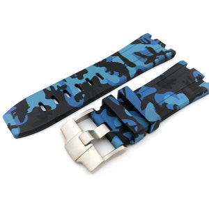 May include: A black and blue camouflage patterned watch strap with a silver buckle.