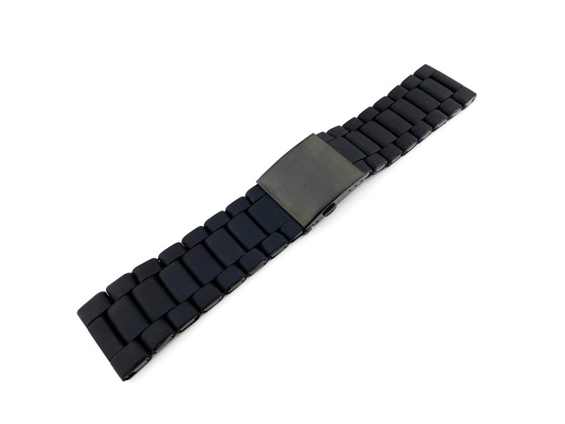 May include: A black metal watch strap with a brushed finish and a clasp.