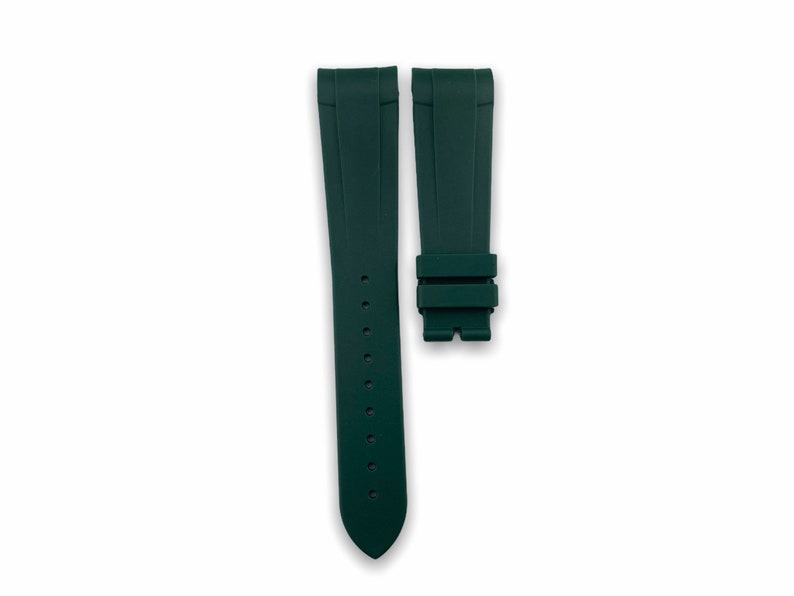 May include: A dark green rubber watch strap with a buckle.