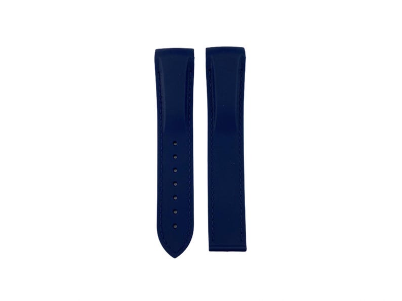 May include: A pair of dark blue watch straps made of rubber. The straps have a smooth, matte finish and are designed for a watch with a lug width of 20mm.