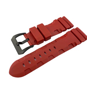 May include: A red silicone watch strap with a black buckle. The strap has a textured design and is designed for a watch with a 22mm lug width.
