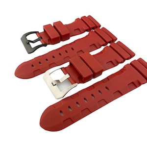 May include: Three red silicone watch straps with black and silver buckles. The straps have a textured design and are designed for a watch.