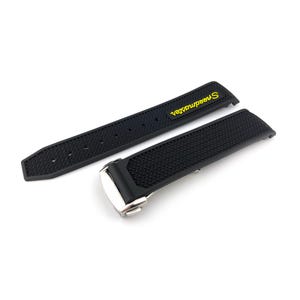 May include: Black rubber watch strap with a silver buckle and the word "Speedmaster" in yellow lettering.