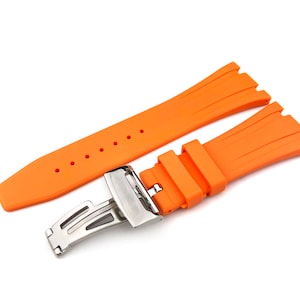 May include: Orange rubber watch strap with a silver buckle. The strap has a textured design and is made of high-quality rubber.