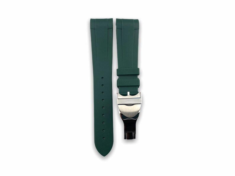 May include: A dark green silicone watch strap with a silver buckle. The strap is designed for a watch with a 22mm lug width.