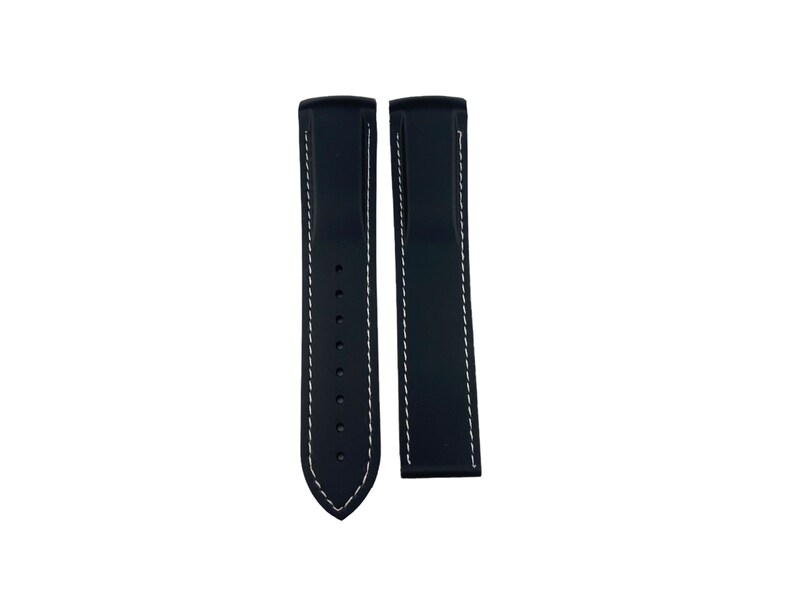 May include: Two black watch straps with white stitching. The straps are made of a rubber-like material and have a pointed end.