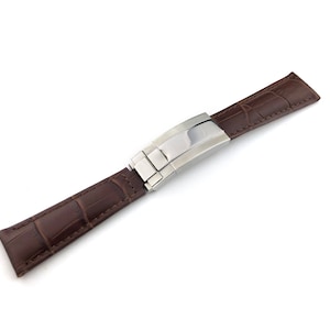 May include: A brown leather watch strap with a stainless steel buckle.