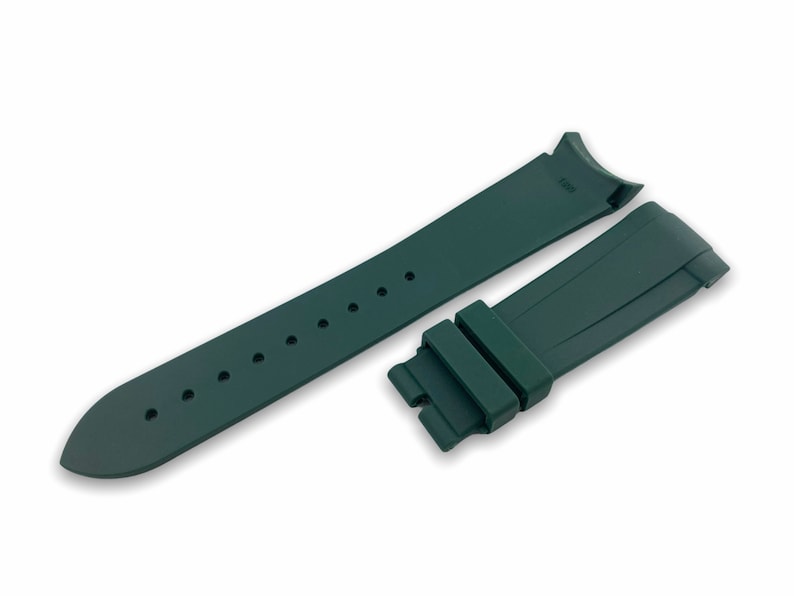 May include: A dark green rubber watch strap with a buckle. The strap is designed for a watch with a 20mm lug width.