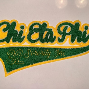 May include: Embroidered patch with the words "Chi Eta Phi" in green with a yellow outline. Below the text is a green pennant shape with gold text that reads "Sorority Inc."