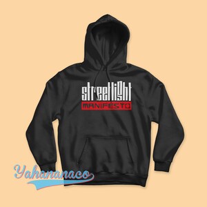 May include: Black hooded sweatshirt with the text "streetlight MANIFESTO" in white and red letters.
