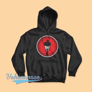 May include: Black hoodie with a red circle and a white silhouette of a street lamp. The circle has white rays radiating from it.