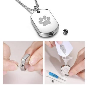 May include: Silver dog tag necklace with a paw print engraved on the front. The tag has a small screw-on lid for holding ashes or fur. The necklace comes with a small funnel and screwdriver for filling the tag.
