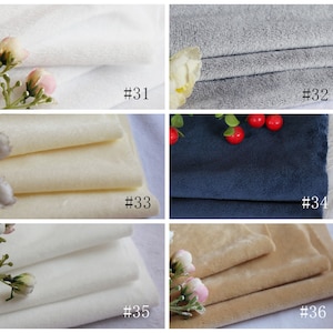 May include: Six fabric swatches in different colors, including white, gray, beige, and blue. The swatches are labeled with numbers 31 through 36.