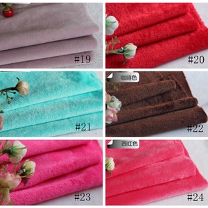May include: A collection of six fabric swatches in different colors, including light purple, red, turquoise, brown, pink, and a darker pink. Each swatch is folded in thirds and labeled with a number.
