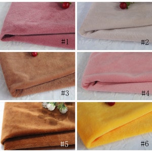 May include: Six fabric swatches in different colors, including pink, beige, brown, and yellow. The swatches are folded and arranged in a grid pattern. Each swatch is labeled with a number from 1 to 6.