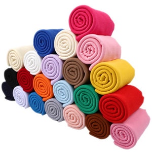 May include: A collection of 20 rolled fabric strips in various colors, including red, blue, green, yellow, orange, pink, white, and black. The fabric is a ribbed knit material.