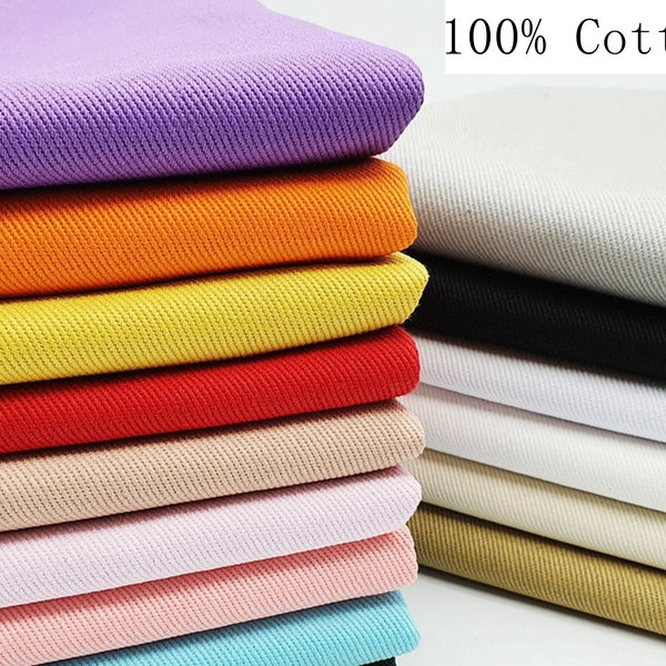 May include: A stack of 100% cotton fabric swatches in various colors, including purple, orange, yellow, red, beige, pink, and blue. The fabric has a subtle ribbed texture.