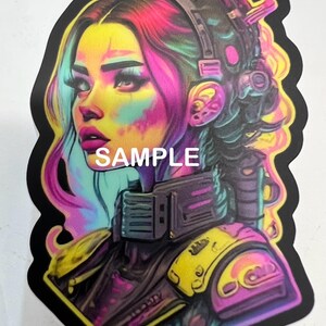 May include: A colorful sticker featuring a cyberpunk-style illustration of a woman with pink and blue hair wearing a headset and futuristic armor. The sticker has a black border and the word "SAMPLE" printed on it.