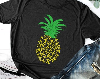 May include: A dark grey t-shirt featuring a yellow pineapple design. The pineapple is made up of the mathematical symbol for pi.