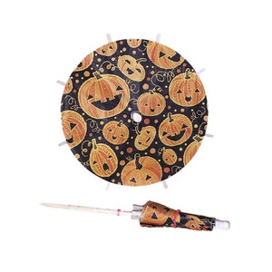 May include: A black and orange Halloween themed table skirt with a pumpkin pattern. The skirt is round and has a white trim. A matching pumpkin patterned umbrella is included.