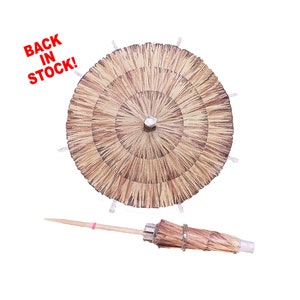 May include: A brown and tan paper cocktail umbrella with a silver metal top. The umbrella is attached to a wooden stick.