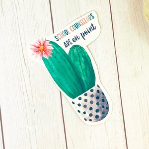 May include: A watercolor illustration of a cactus in a pot with black polka dots. The cactus has a pink flower and the text "School Counselors Are on Point" is written above the cactus.