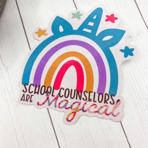 May include: A colorful rainbow sticker with a unicorn horn and stars. The text "School Counselors Are Magical" is written on the sticker.