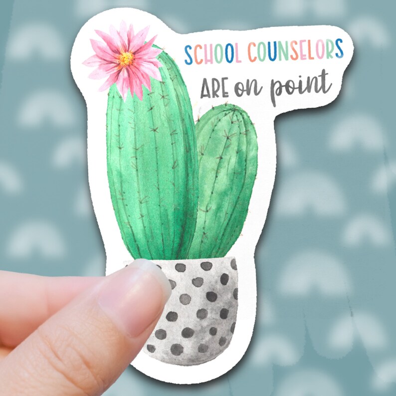 May include: A sticker with a watercolor illustration of a cactus in a polka dot pot. The text "SCHOOL COUNSELORS ARE ON POINT" is written in colorful letters above the cactus.
