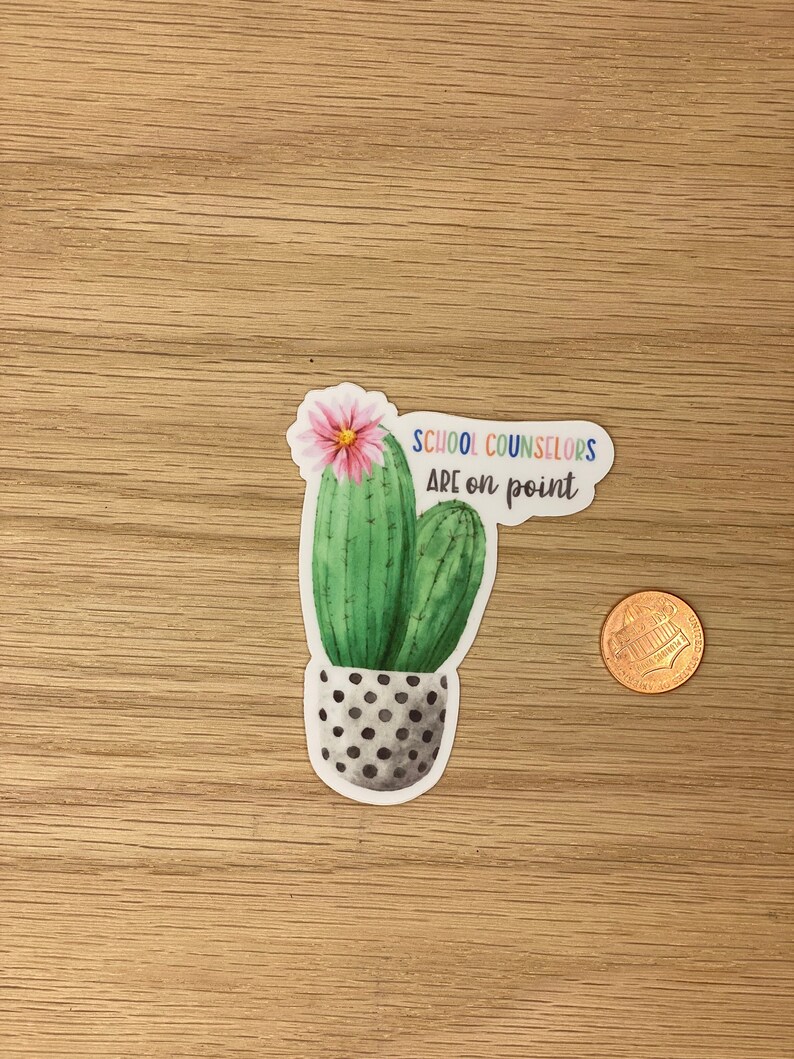 May include: A sticker with a green cactus in a black and white polka dot pot. The cactus has a pink flower on top and the text "School Counselors Are on Point" in rainbow colors.