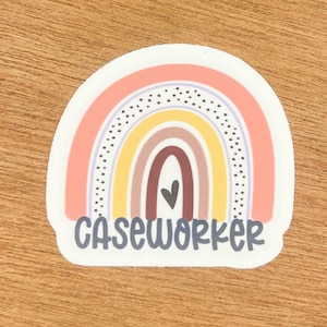 May include: A rainbow sticker with a heart in the center and the text "Caseworker" below. The rainbow is made of pink, yellow, brown, and red.