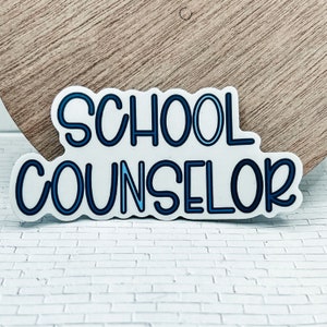 May include: A white sticker with blue outline lettering that reads "SCHOOL COUNSELOR".
