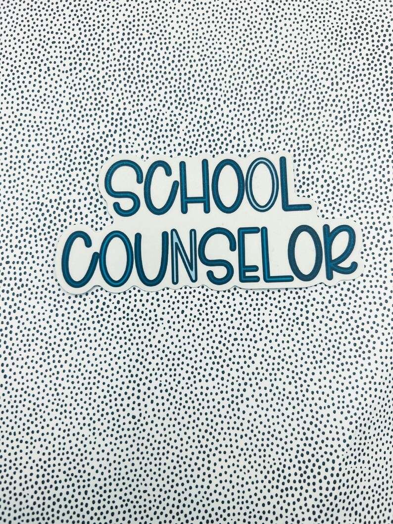 May include: A blue and white sticker with the text "SCHOOL COUNSELOR" in a bold, outlined font.