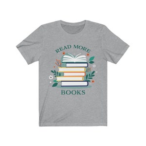 May include: Gray t-shirt with the text "Read More Books" and a stack of books with a green leafy design.
