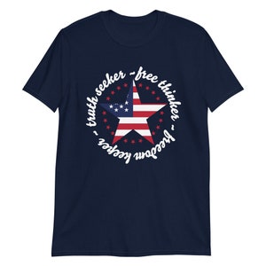 Puede incluir: Camiseta azul marino con un dise&ntilde;o de estrella blanca y el texto "truth seeker - free thinker - freedom keeper" alrededor de la estrella.