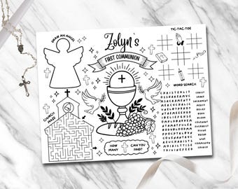 May include: A black and white printable activity sheet for a first communion celebration. The sheet features a church maze, a draw an angel section, a noughts and crosses game, a word search, and a "how many can you find?" section with a chalice and grapes. The sheet is titled "Zolyn's First Communion".