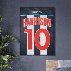 May include: A black and white striped jersey with the name "HARRISON" and the number "10" in red. The jersey has the date "23.01.12" printed on it.
