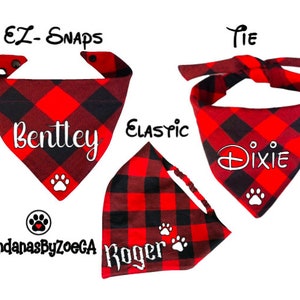 May include: Three red and black plaid dog bandanas with white paw prints and personalized names: Bentley, Dixie, and Roger. The bandanas are available in three styles: tie, elastic, and EZ-Snaps.
