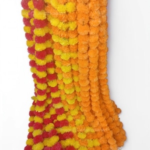 May include: A garland of artificial marigold flowers in red, yellow, and orange. The garland is made of multiple strands of flowers, creating a thick and full look.