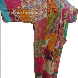 May include: A long, colorful patchwork kimono with a variety of floral and geometric patterns. The kimono is made of quilted fabric and has a relaxed fit.